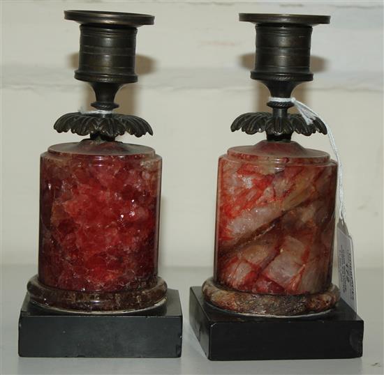 A pair of Regency bronze and red fluorospar / Blue John mounted candlesticks, 6.25in.